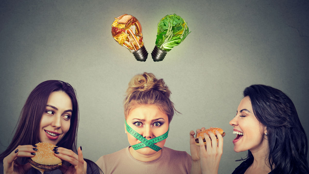 Stressed vegan surrounded by hamburger eaters