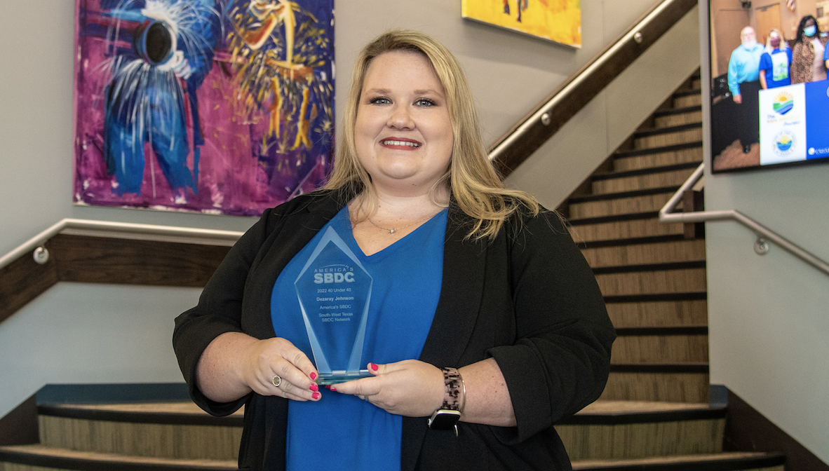 Dezaray Johnson with her Top 40 Under 40 Young Professional Award from America's SBDC