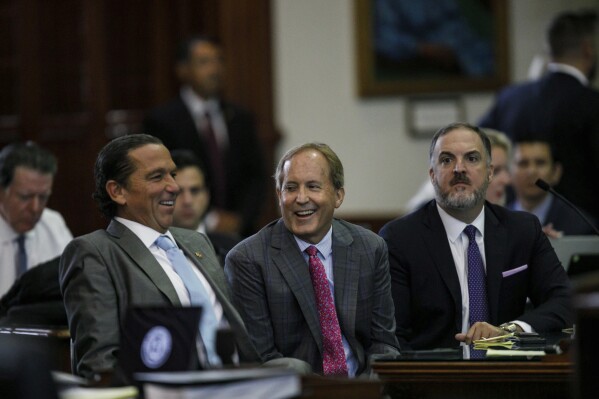 Tony Buzbee (left) with Paxton and associate defense attorney Mitch Little. (AP)