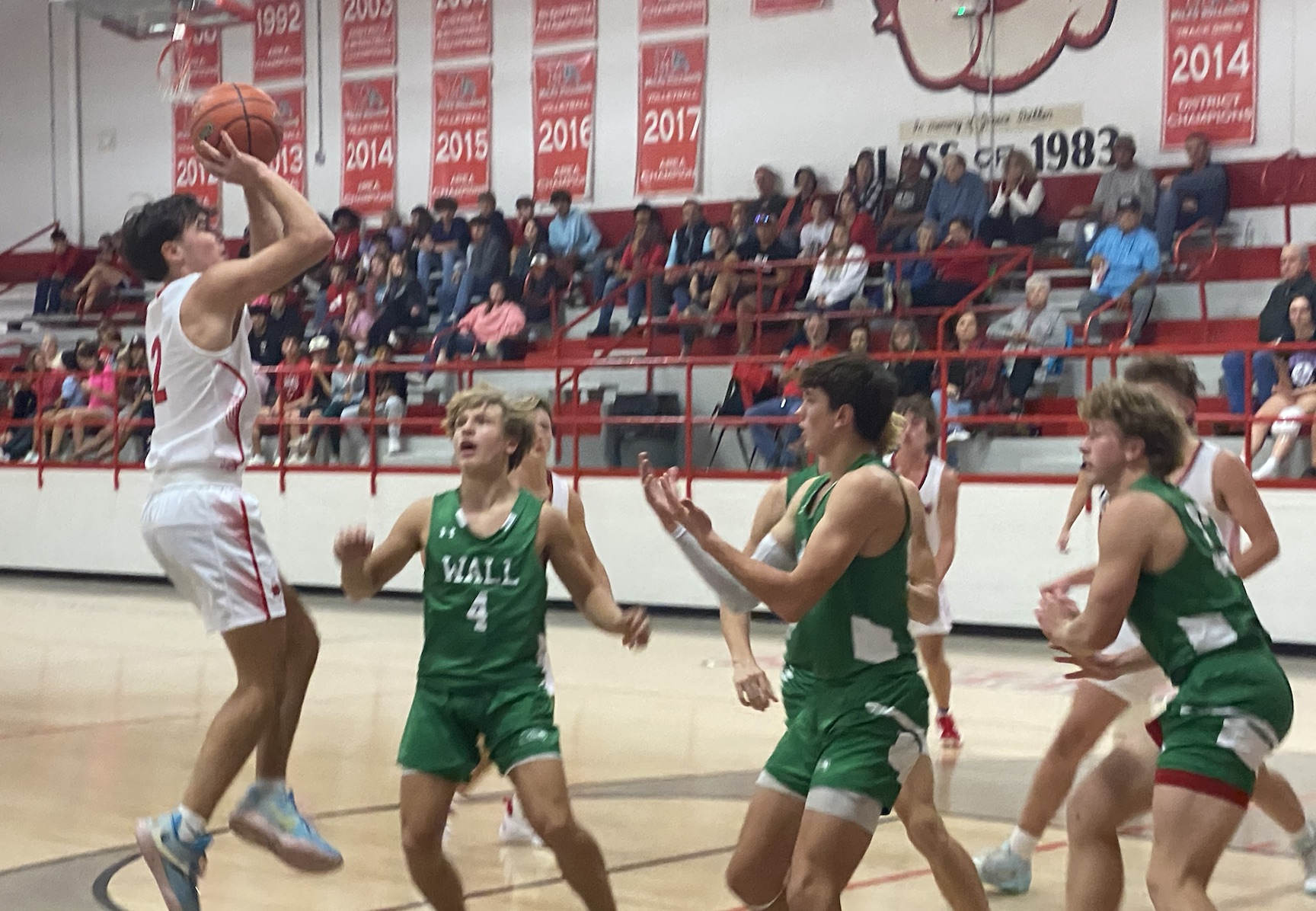 Miles Bulldog Cooper Ellison goes to make a shot over three Hawks.