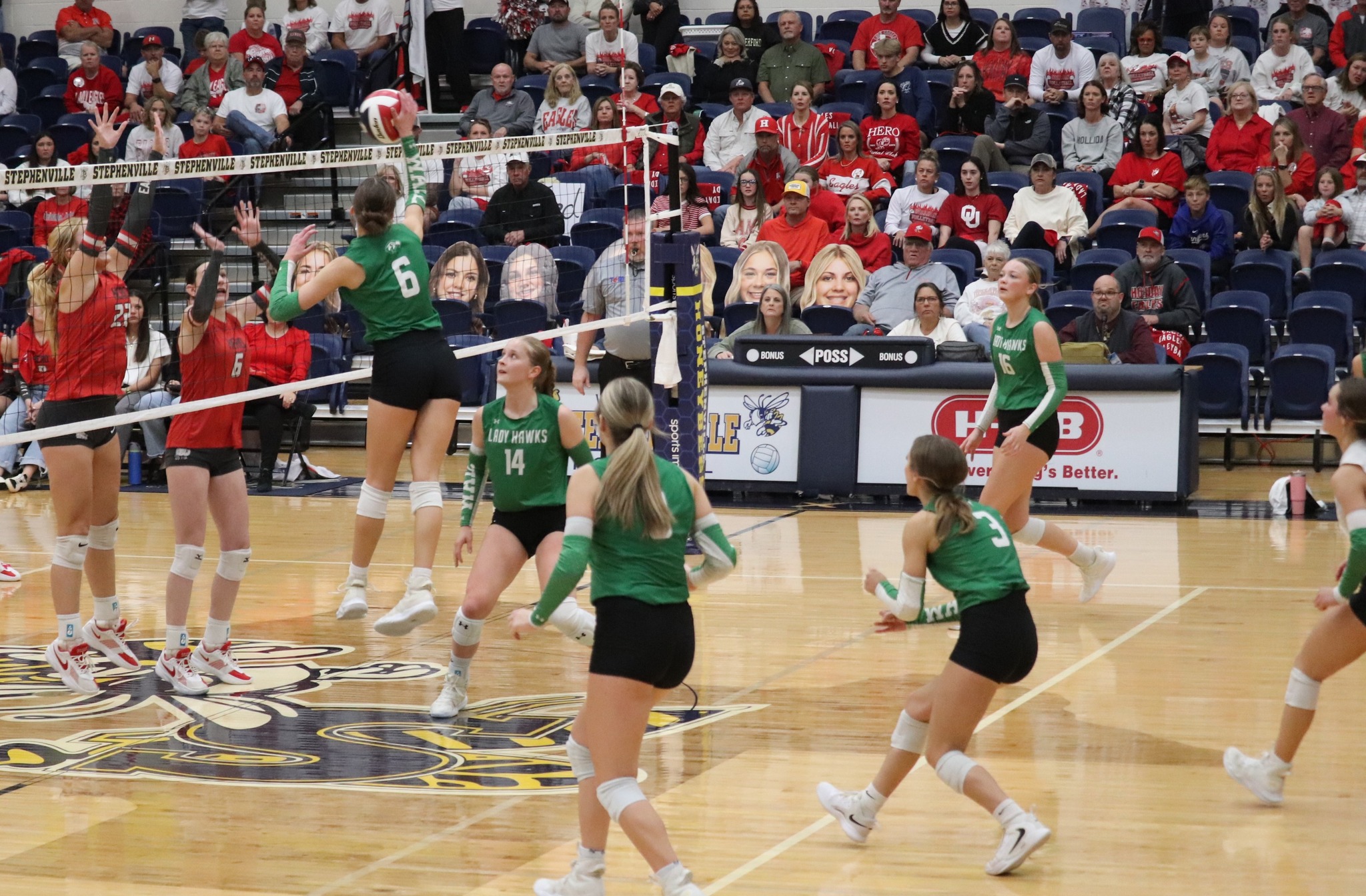 Wall's Peyton Dickson (6) rises up for a kill while Kynlee Stevens (14) looks on during the Lady Hawks' win over Holliday in the regional final.