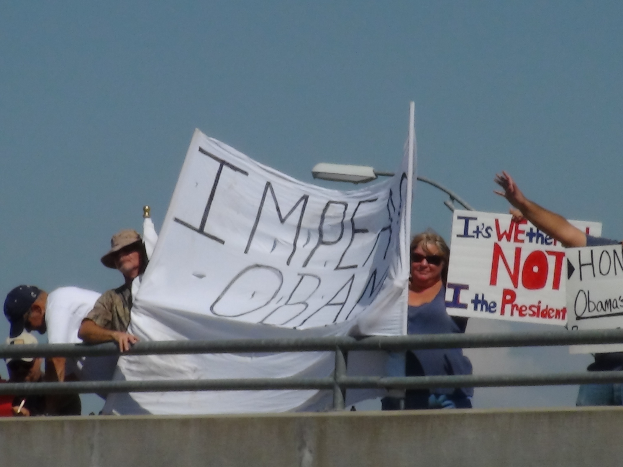 'Overpasses for Obama's Impeachment' held up signs on the Glenna St. overpass (LIVE! photo by Cheyenne Benson)
