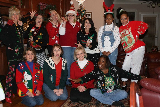 Women pose for a picture in ugly Christmas sweaters (photo courtesy of convenientbuys.com)