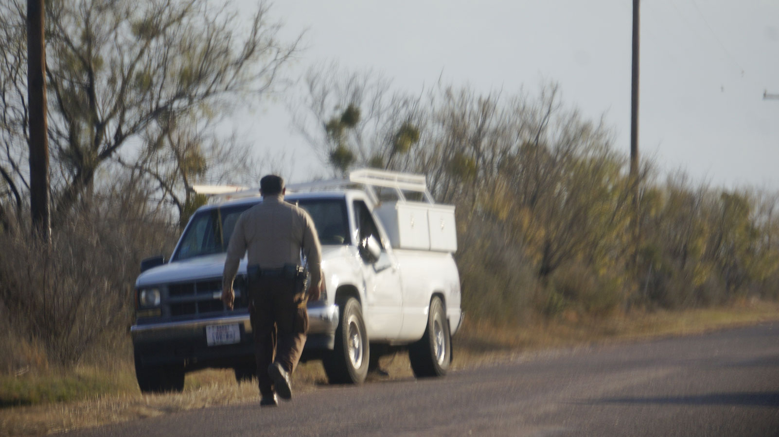 TGCSO deputy approaches the suspect's abandoned vehicle on E. Red Creek Road. (LIVE! Photo/John Basquez)