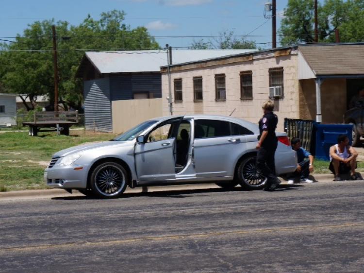 Police wait by Fitchett's Chrysler Sebring after he fled with a shotgun on June 6. (LIVE! Photo/John Basquez)