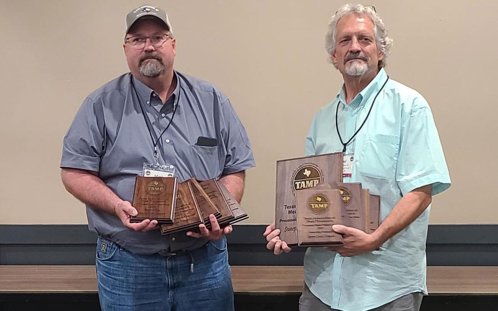 Mark and Paul Sklenarik of Sklenarik's Smoked Meats, Inc. in Miles show off awards won at the 2022 TAMP Convention at Texas A&M University on August 8.
