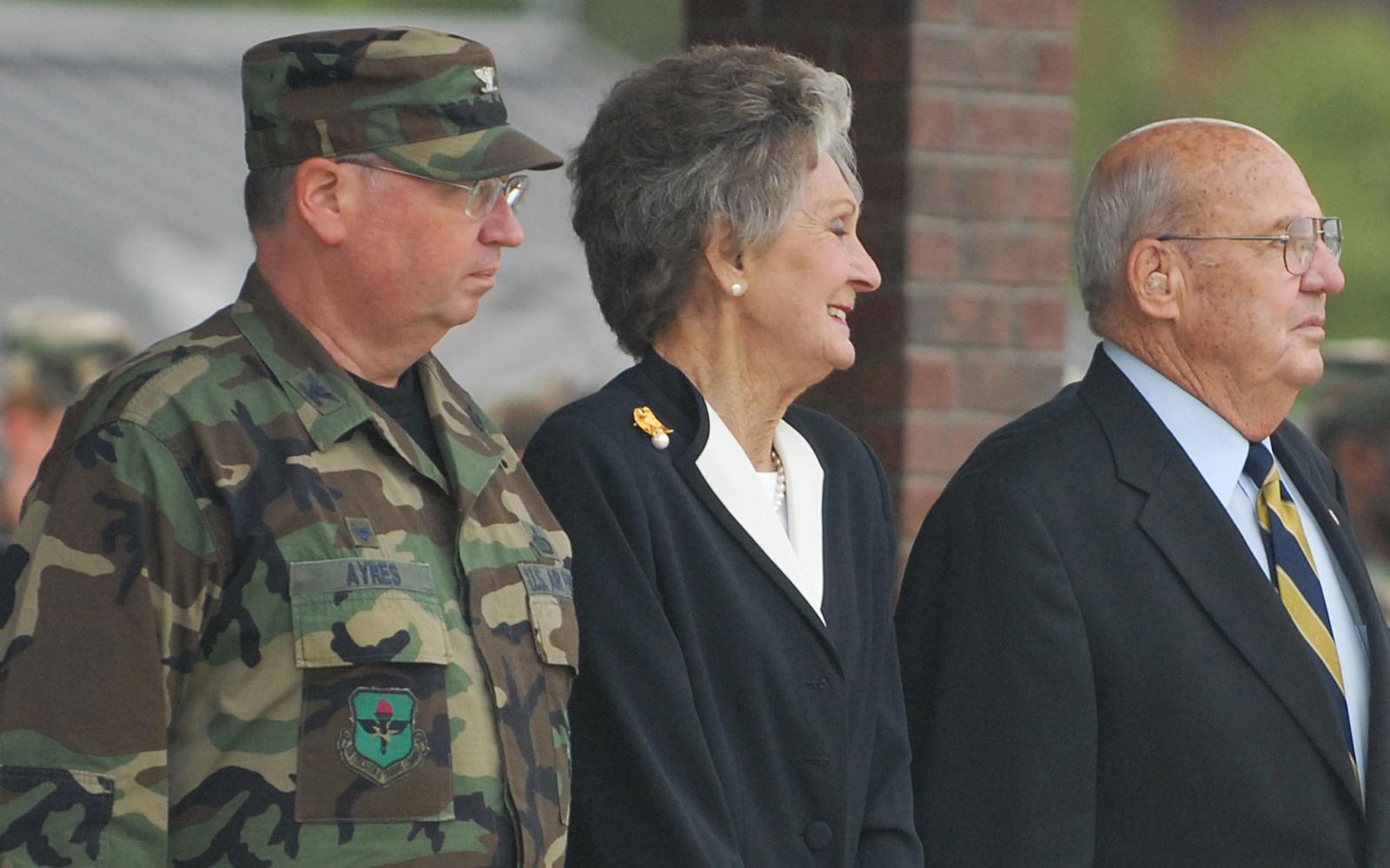 From left to right, Col. Richard Ayres, 17th Training Wing Commander; JoAnne Powell and retired Col. Charlie Powell stand at attention during the playing of the Armed Forces Medley Sept. 11, 2008. Colonel and JoAnne Powell were recognized for their continuing service and dedication to the people of Goodfellow Air Force Base. (U.S. Air Force photo by Tech. Sgt. Gina O’Bryan)