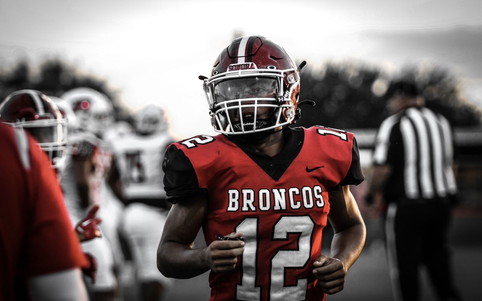 Sonora junior Jaime Buitron jogs onto the field.