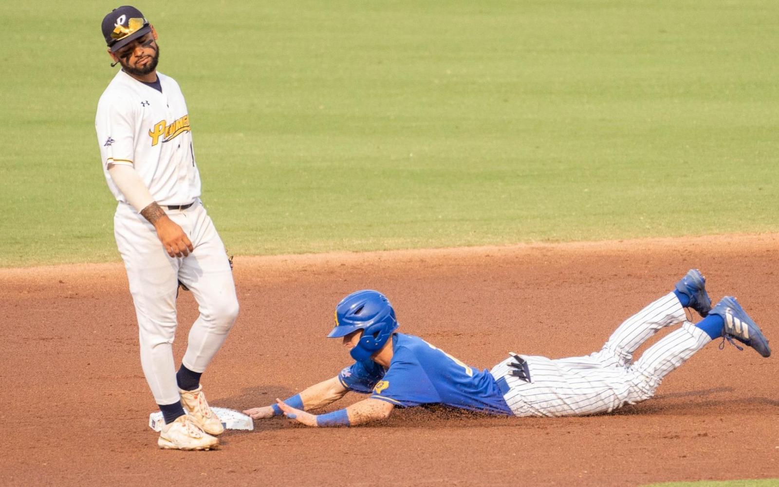 Jackson Hardy dives for the base.