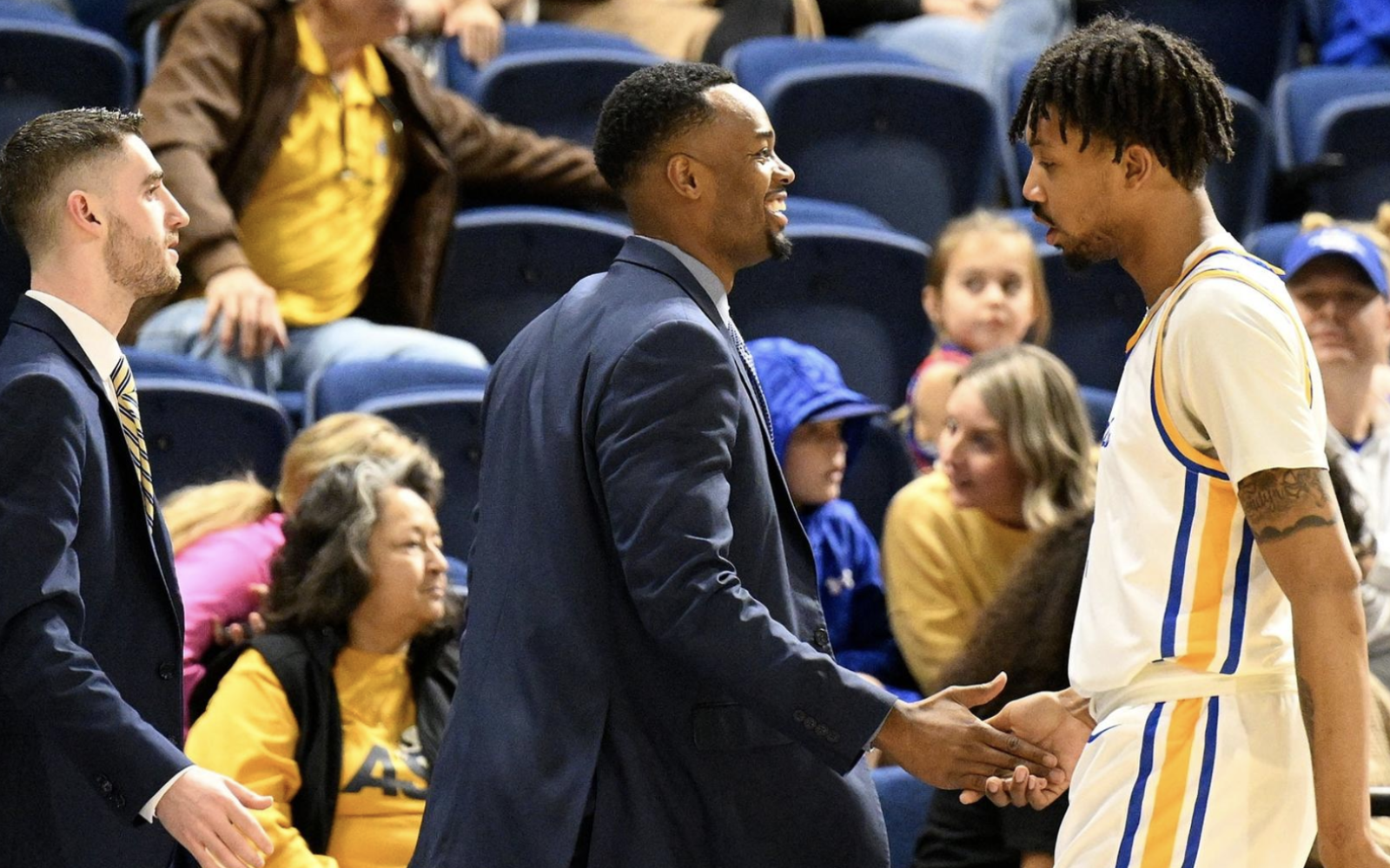 Coach Mark Rutledge shakes hands with Devaughn Thomas (Right)