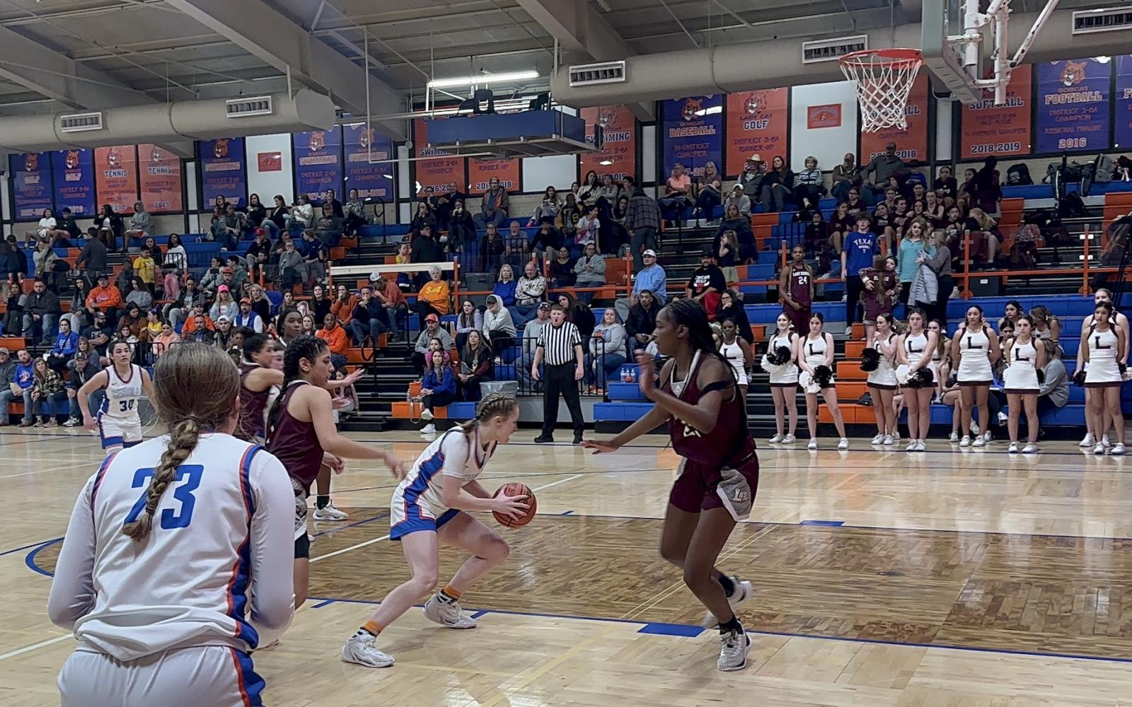 Lady Cats Anna Wierzowiecki drives to the basket against Midland Legacy