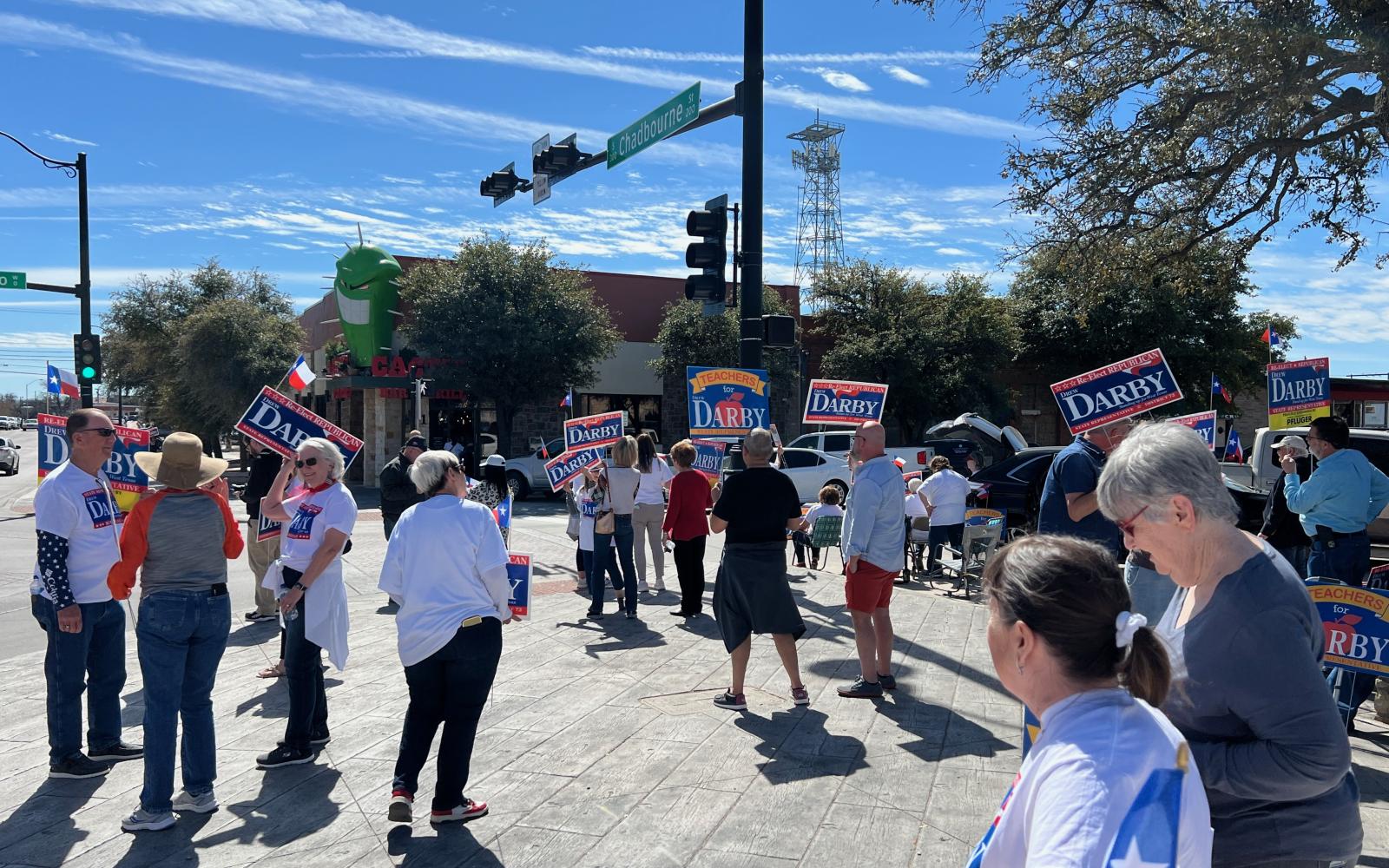 Pro-Drew Darby supporters demonstrate outside the Angry Cactus restaurant where Gov. Greg Abbott was campaigning for Darby's opponent on Feb. 23, 2024.