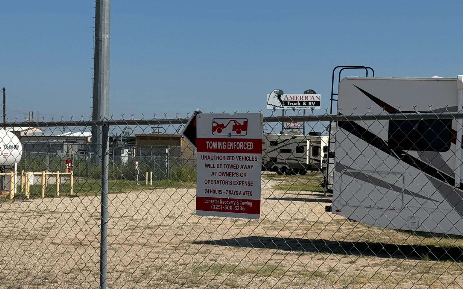 American RV posted Towing signs along its fence line.