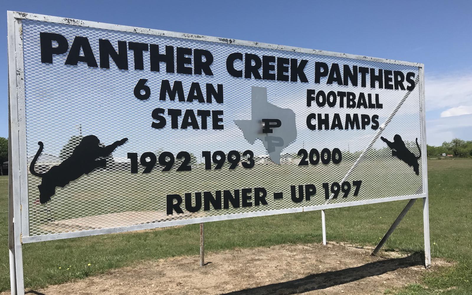 A sign at Panther Creek High School displays the football program's accomplishments.