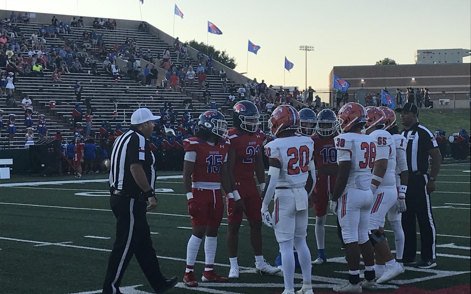 Captains for San Angelo Central and Abilene Cooper meet for the coin toss Friday, Sept. 13, 2024, at Shotwell Stadium in Abilene.