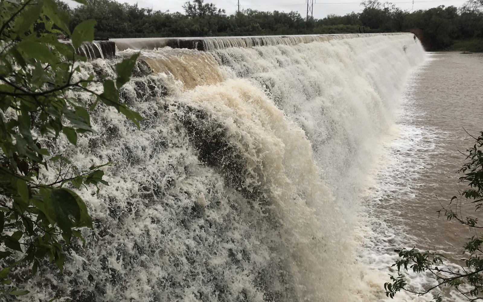 Water from Elm Creek rushes over the dam at Ballinger's City Park on Tuesday, Sept. 3, 2024. 