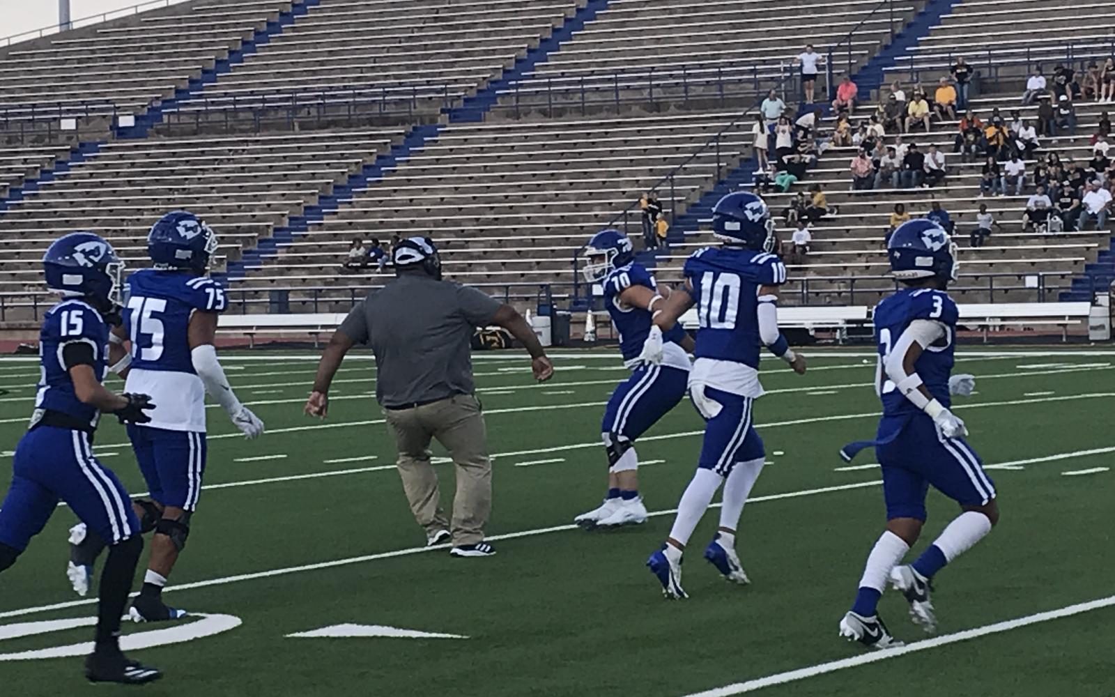 Lake View defensive lineman Trey Henry and a Chiefs coach prepare to jump in celebration of a Lake View defensive stand in the fourth quarter against Snyder on Friday, Sept. 6, 2024, at San Angelo Stadium.