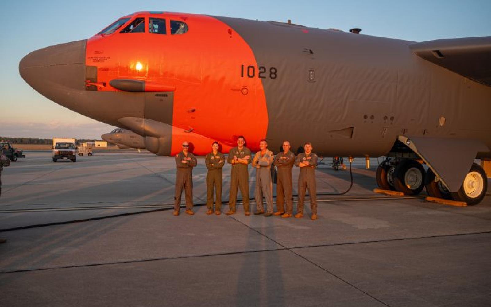 U.S. Air Force Aircrew from the 49th Test and Evaluation Squadron, 53d Wing, gather beside a U.S. Air Force B-52H Stratofortress with a special orange paint scheme at Barksdale Air Force Base, La. Sept. 30, 2024.