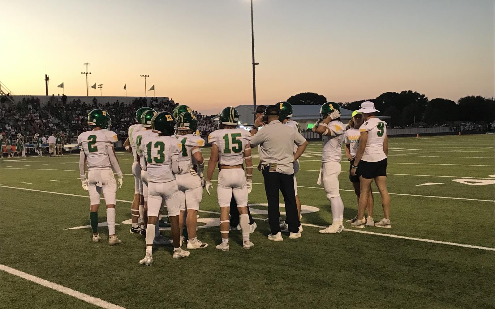 Idalou's players and coaches talk before taking the field against Wall on Friday, Oct. 4, 2024.