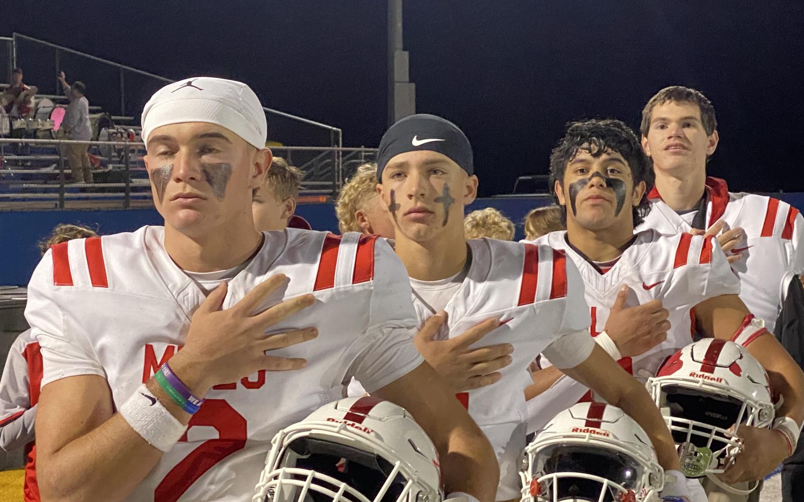 The Miles football team stands for the national anthem before its first-round playoff game against Lindsay in Brock on Thursday, Nov. 14, 2024.
