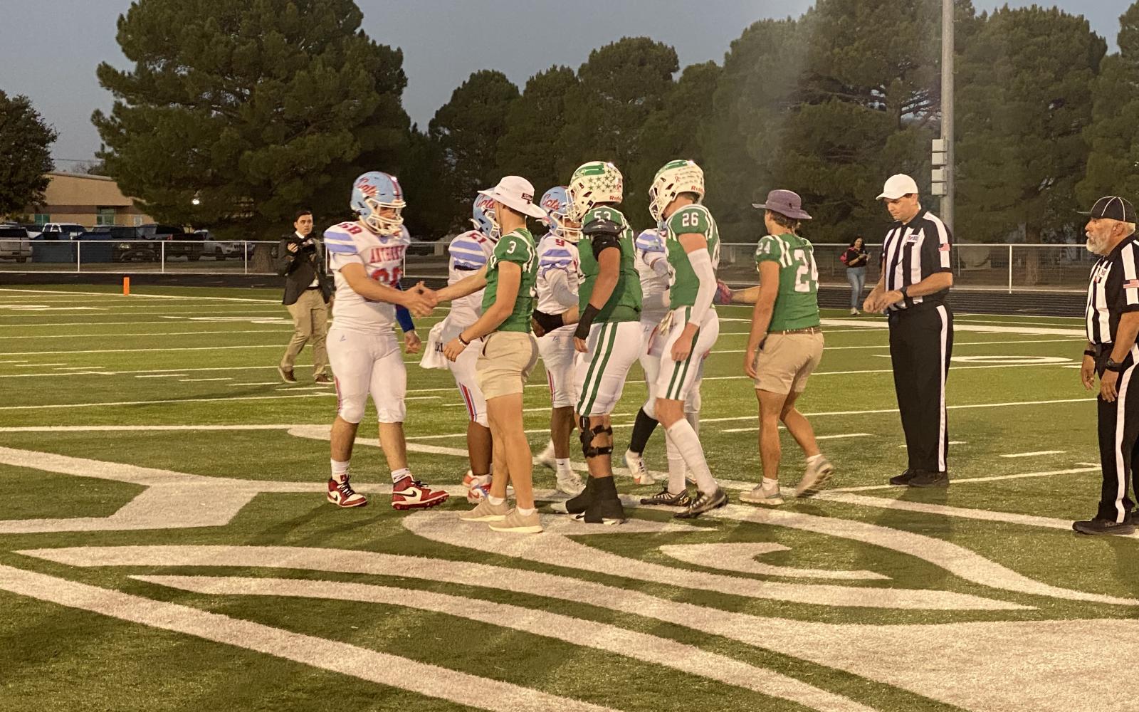 Captains for Wall and Anthony meet at midfield for the coin toss prior to their first-round playoff game Friday, Nov. 15, 2024.