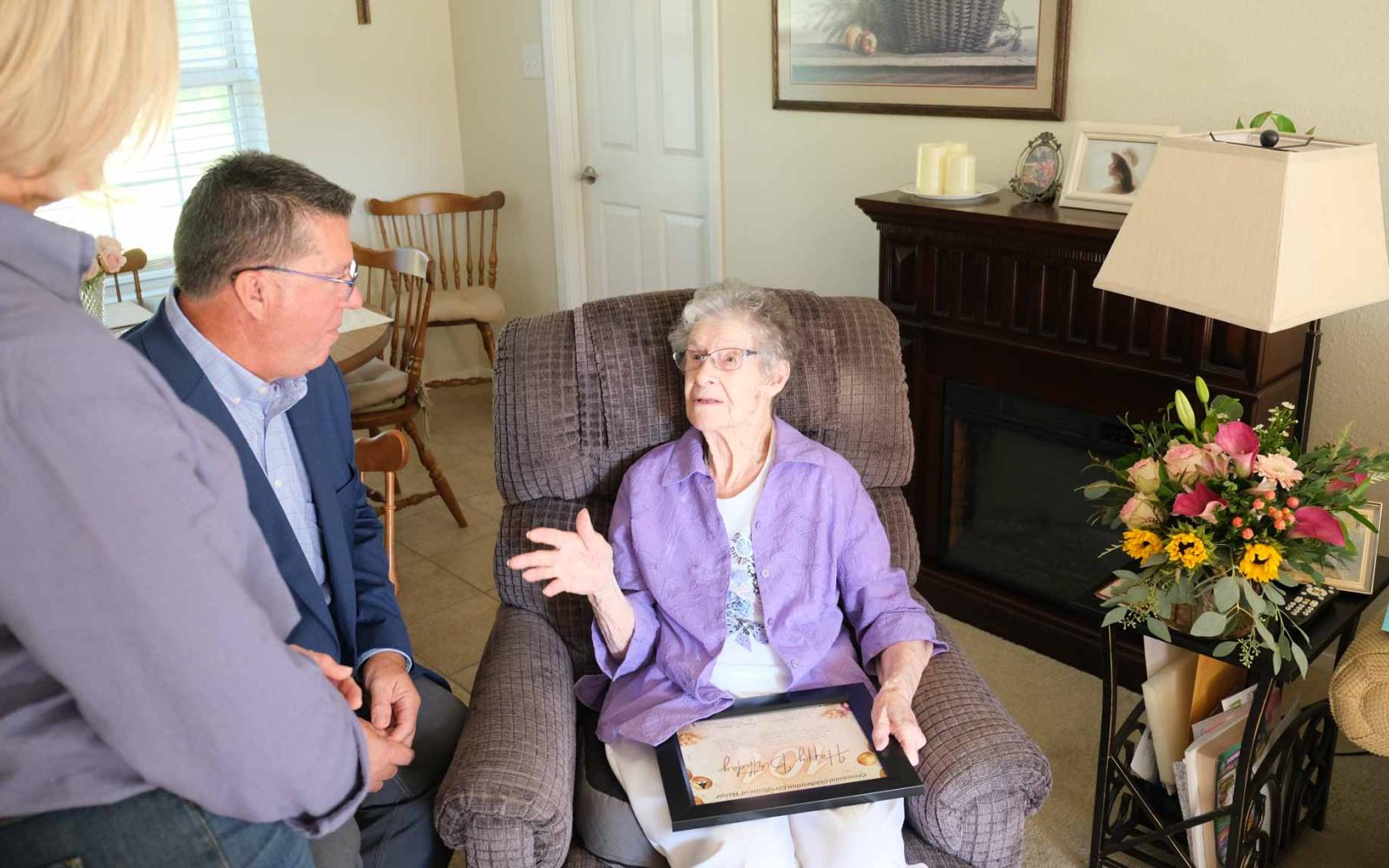 San Angelo Mayor Tom Thompson listens as Ida Walter shares stories from her life during her 101st birthday celebration on Friday. 