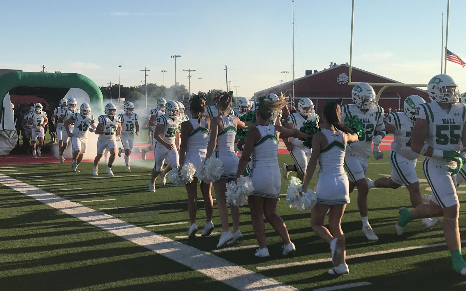 The Wall Hawks run onto the field before their football game with Jim Ned in Tuscola on Friday, Sept. 12, 2025.