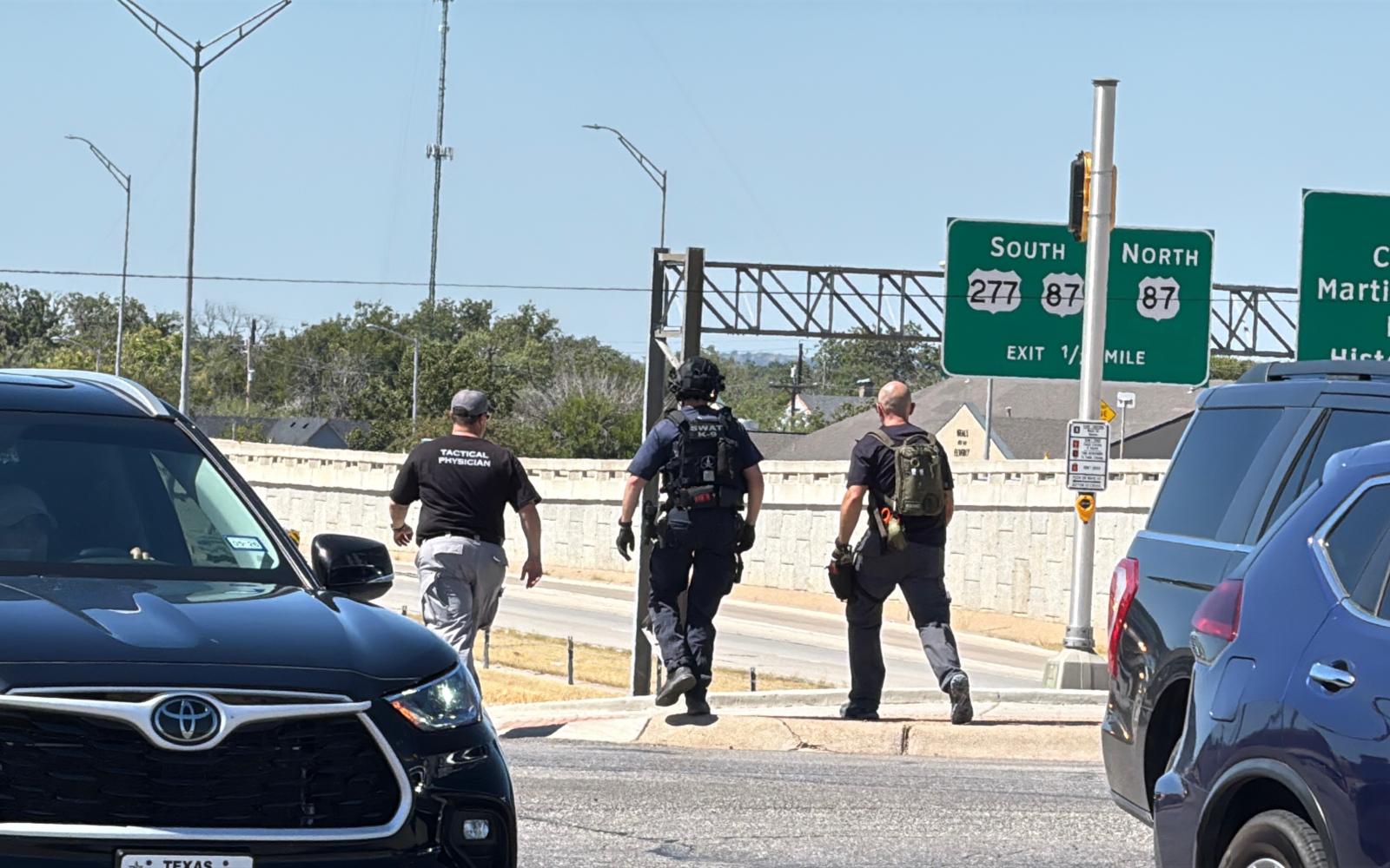 Law enforcement are shown at the scene of a man threatening to jump from the Main Street overpass onto the Houston Harte Expressway.