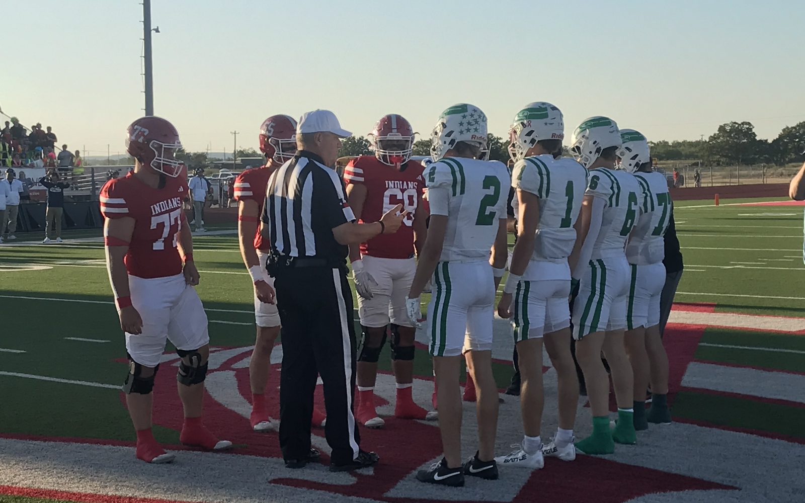 Captains for the Wall Hawks and Jim Ned Indians meet at midfield for the coin toss before their football game Friday, Sept. 12, 2025.