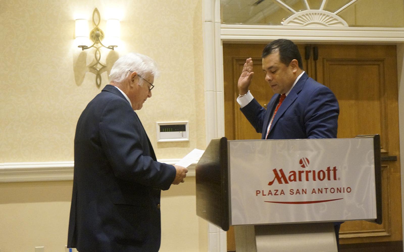 Armando Vasquez swears in his son, Tim Vasquez, as President of the Texas Police Association in 2015