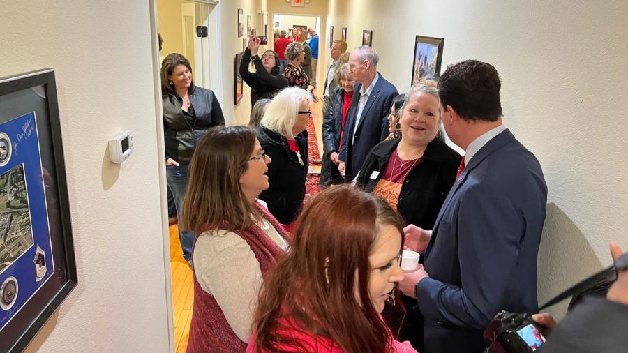 Pre. Pfluger talks with Debbie Cross and Ami Berez Mizell-Flint in the crowded hallway during the grand opening reception on Tuesday, Feb. 14, 2023.