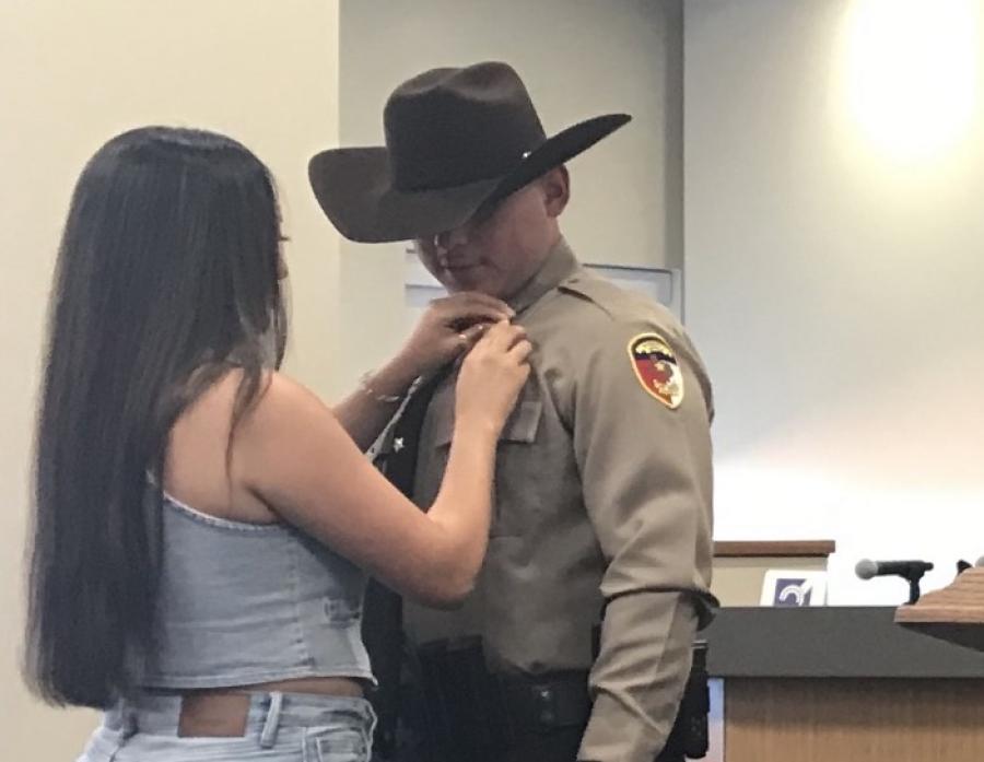 New Tom Green County Sheriff's Deputy Ryan DeLaCruz had his badge pinned on by his wife, Samantha, during a ceremony Wednesday, July 3.