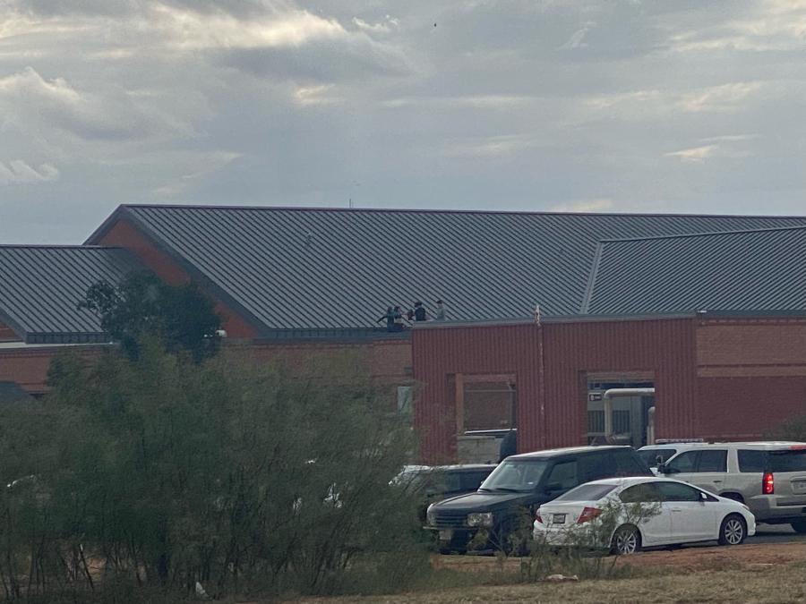 Individuals on the roof of River Crest Hospital as law enforcement responds to a special call in San Angelo, TX.