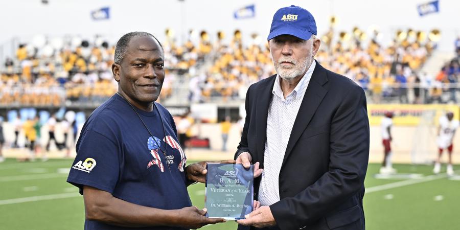 ASU President Ronnie Hawkins Jr. (left) with Dr. William Buche during halftime of the Rams' Military Appreciation Day game