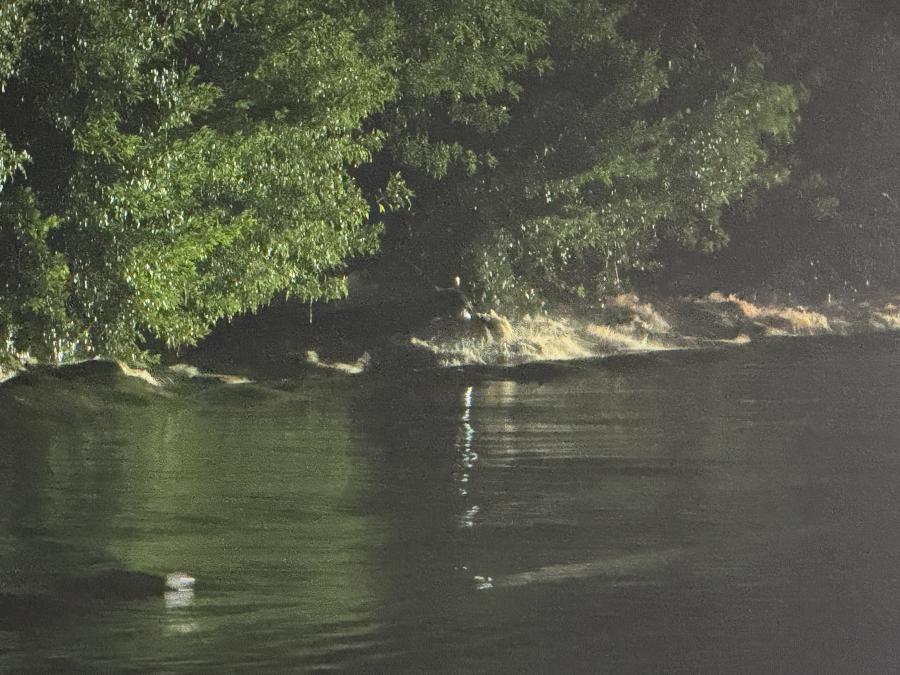 A partially submerged car is barely visible under the floodwaters in San Angelo as heavy rains lead to widespread flooding.