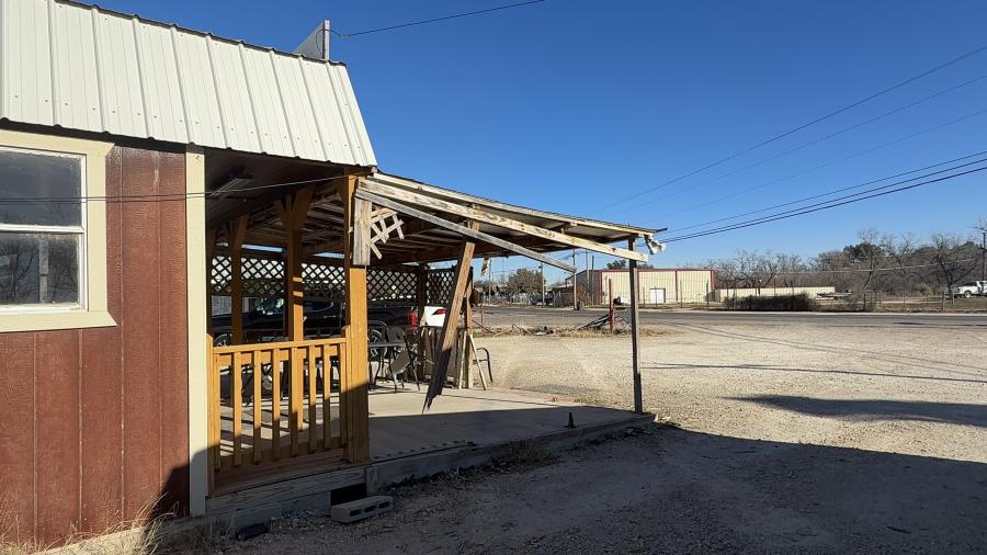 Visible tire marks show the direction the driver was traveling before striking the Donut Palace in Grape Creek
