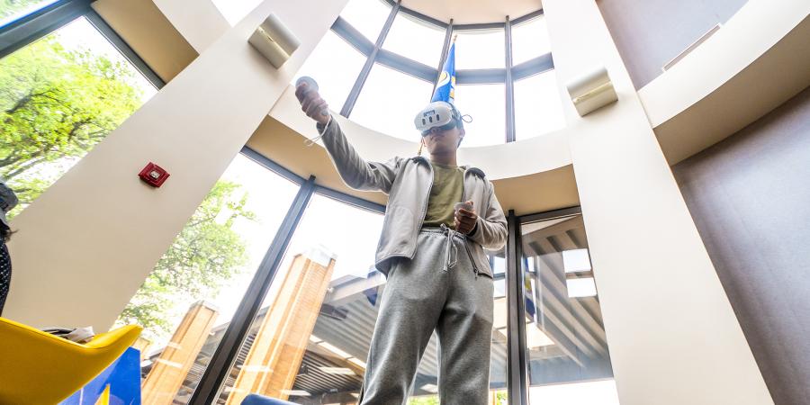 Student in AR goggles at ASU's 2025 Youth Cyber Expo