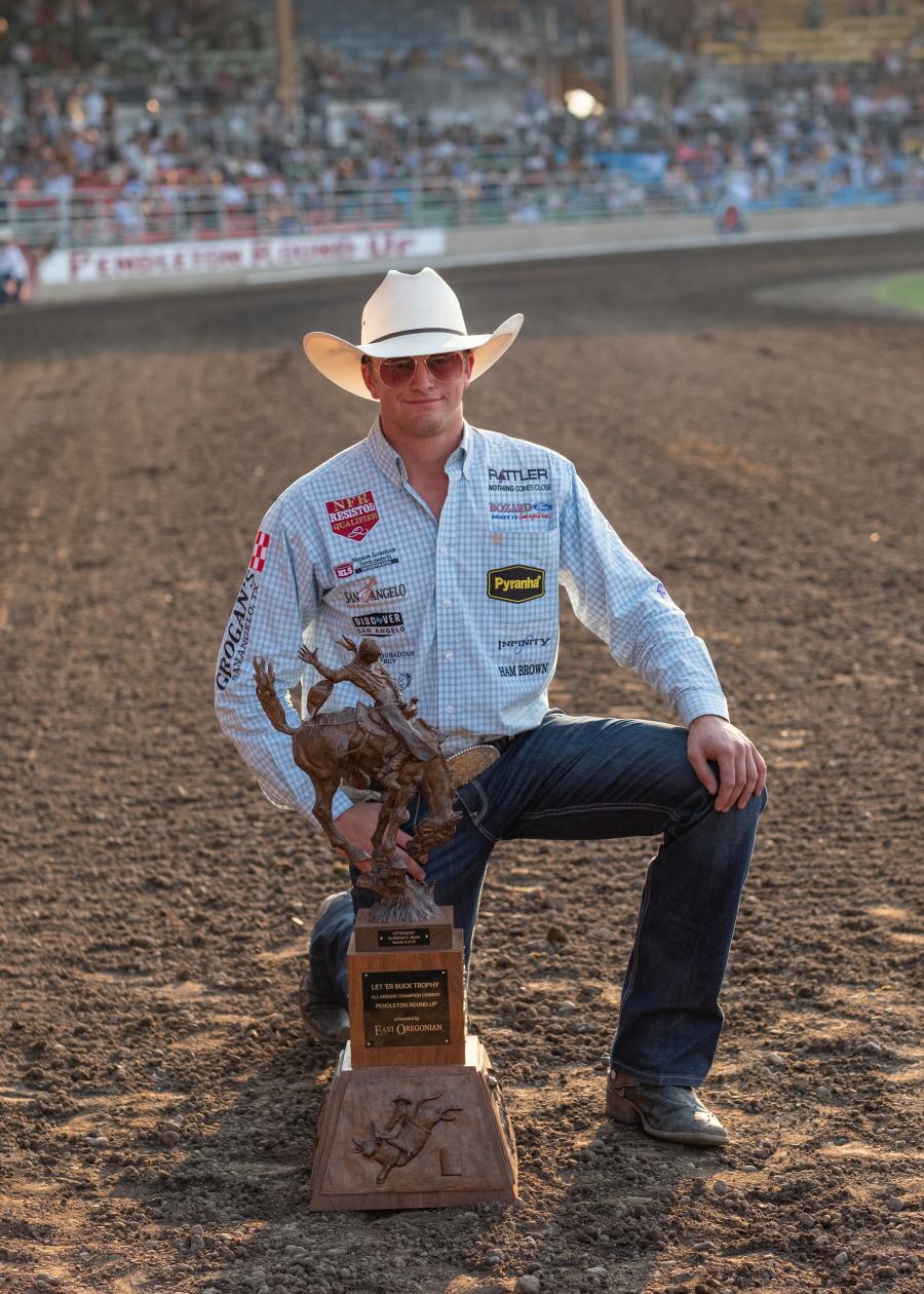 Dylan Hancock of San Angelo, Texas, holds the East Oregonian Let ‘er Buck Trophy for winning the all-around title on Sept. 13, 2025, at the Pendleton Round-Up finals. (Yasser Marte/East Oregonian)   Read more at: https://eastoregonian.com/2025/09/14/unforgettable-rodeo-glory-at-pendleton-round-up-finals/