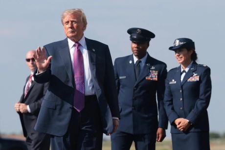 U.S. President Donald Trump waves to supporters after disembarking Air Force One at Ellington Field Joint Reserve Base in Houston on Aug. 27, 2026.