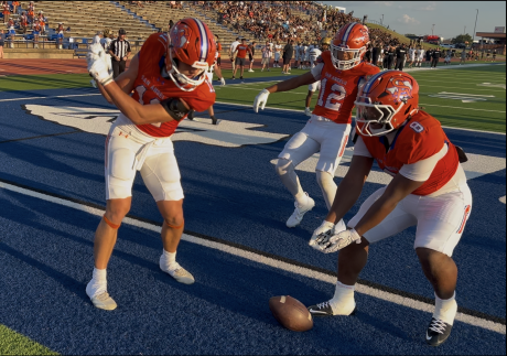 Central's Tucker Beaty does a golf celebration while Ellis Johnson (12) and Zey Johnson (8) look on after a touchdown against Abilene High on Friday, Aug. 28, 2026, at San Angelo Stadium.
