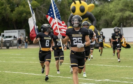 The Menard football team runs onto the field during the 2026 season.