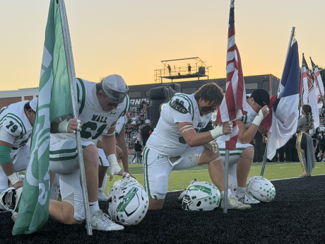 The Wall Hawks kneel before their game at Llano on Friday, Oct. 9, 2026.