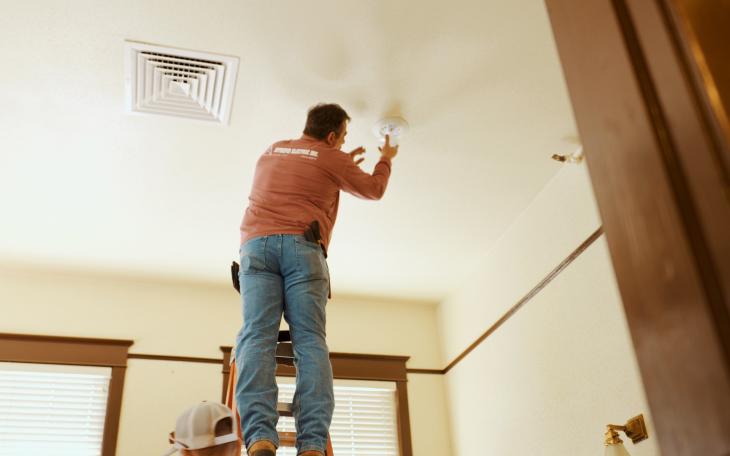 Intrepid Electric's Randy McIntyre installs a light fixture in the historic Railway Museum in San Angelo. LIVE! Photo/Manny Diaz