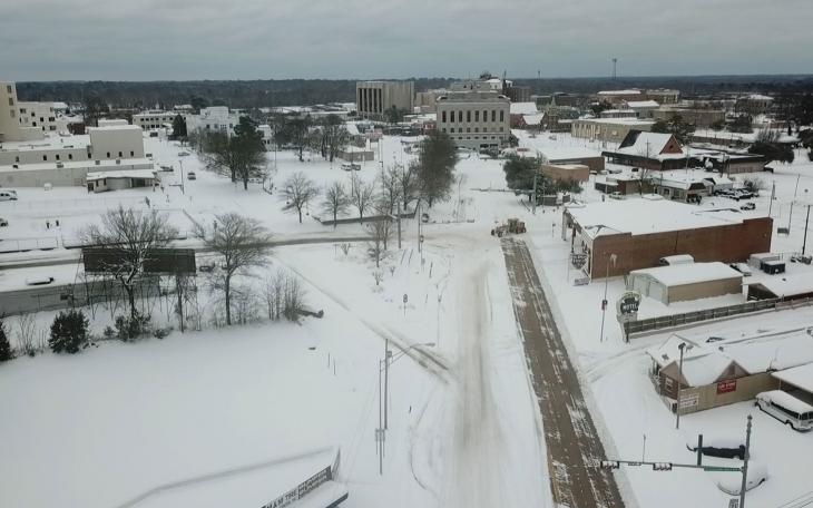 This drone photo was taken 2 days later 2 miles up State Line from where Peek filmed the infamous Feb. 16 video. The Arkansas road-grader repurposed as a snow plow was just arriving. On this section of the road, Arkansas was late plowing.