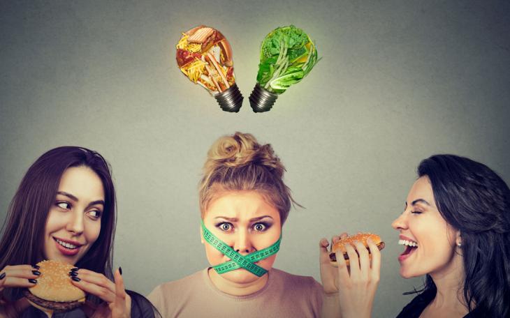 Stressed vegan surrounded by hamburger eaters