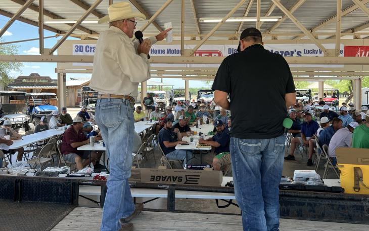 Auctioneer Bill Smith raises money for the Wall ISD baseball field lights on June 18, 2022