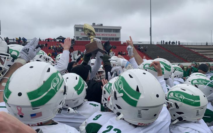The Wall Hawks holds the trophy for winning the Regional Semi-Finals in the 2022 State Football Playoffs