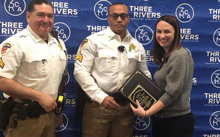 Mental Health Sergeant Quentin Williams and Corporal Chris Roque (left and center) receive award.