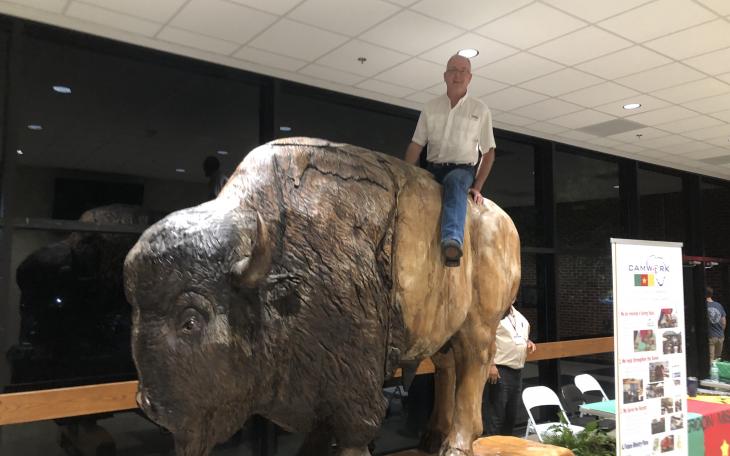 the author atop a giant wooden buffalo