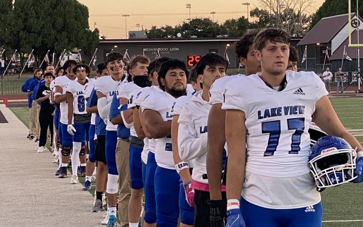 Lake View lines up for the National Anthem before taking on the Brownwood Lions at Gordon Wood Stadium
